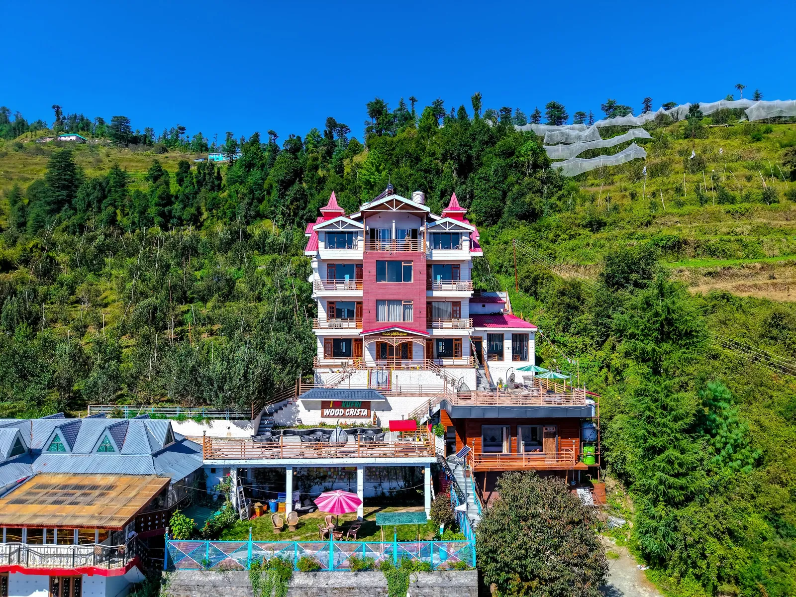 Wood Crista's front elevation with its red-roofed towers