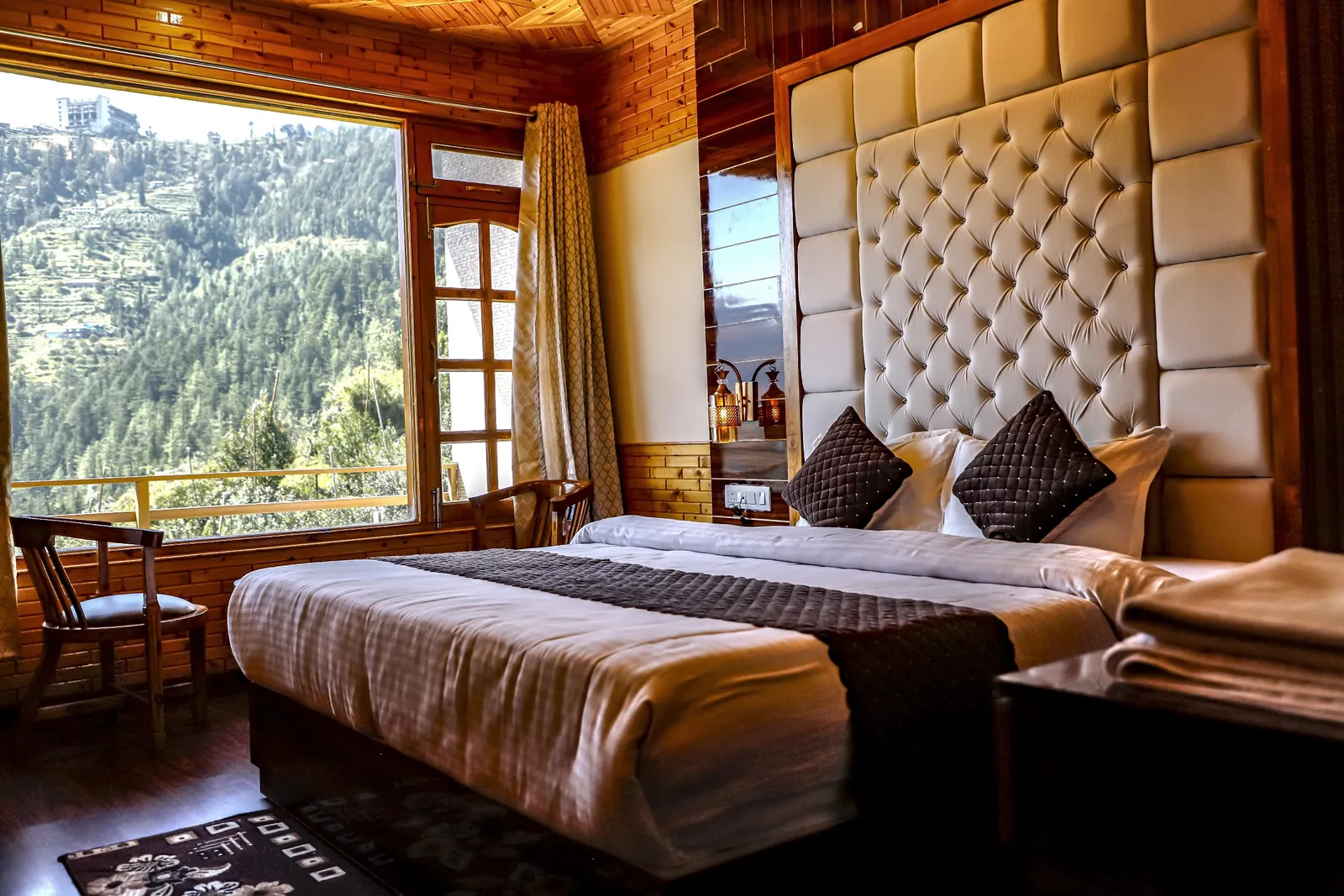 Premium room: tufted headboard beside a valley-facing window